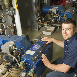 man working on a commercial boiler