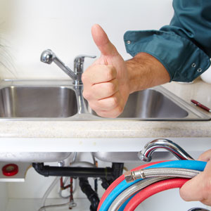 plumber working on a kitchen sink